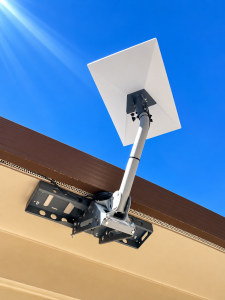 Starlink satellite dish installed on a roof eave with secure mounting bracket and cable routing